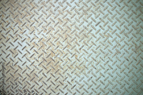 Steel floor for background or texture. Front view of a rusty panel with non-slip surface.