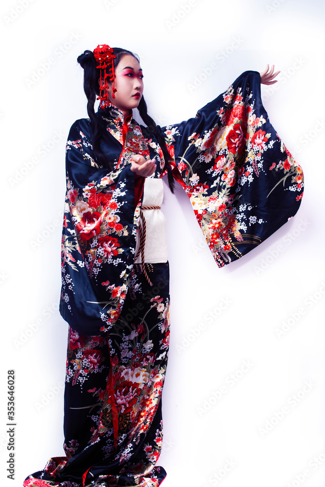 young pretty geisha in black kimono with sakura, asian ethno closeup on white background isolated young pretty geisha in black kimono with sakura, asian ethno closeup on white background isolated