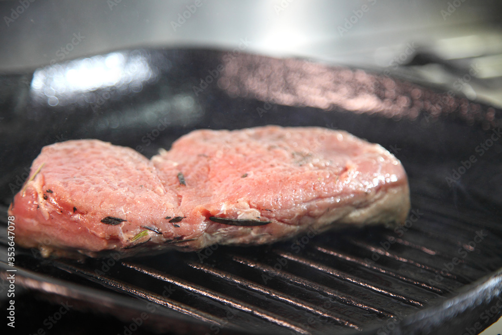 Grilling steak on a grill pan. Chef making steak. Beef tender steak on the grill pan. Grilling steak on a grill pan. Chef making steak. Beef tender steak on the grill pan.