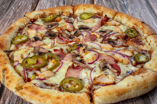 American pizza with chicken bbq and jalapeno peppers