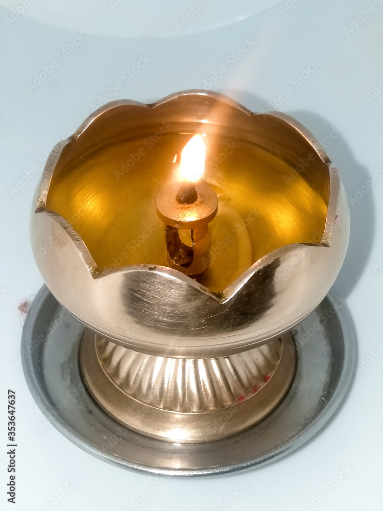 Burning Oli lamp of diya isolated on white background
