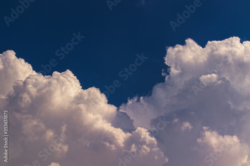 blue sky with cumulus clouds at the base of image