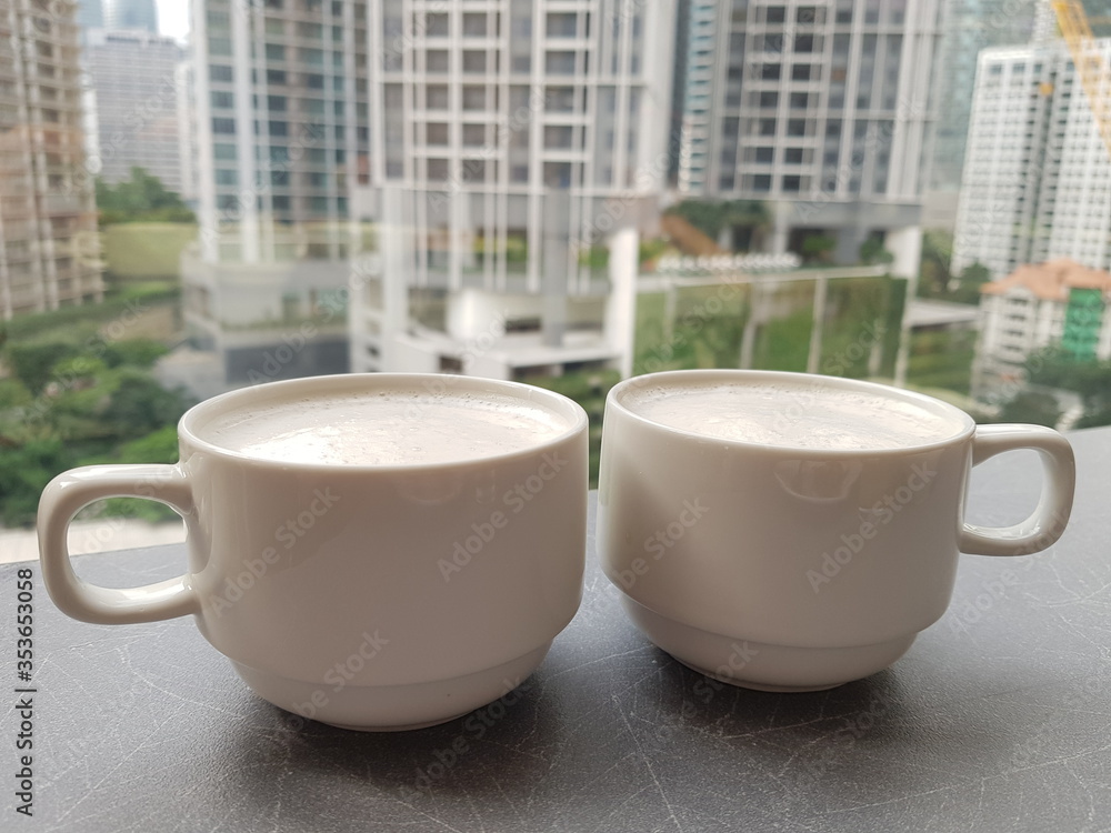 Selective focus on twin cups with white coffee