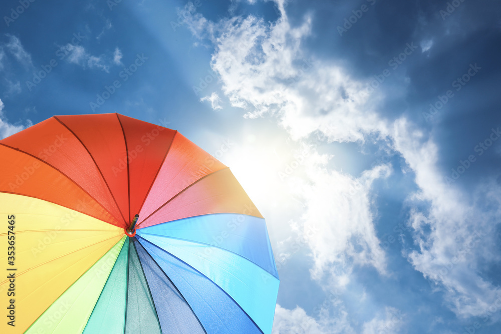 Modern color umbrella against blue sky. Sun protection