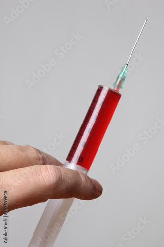 Disposable medical plastic syringes in hand