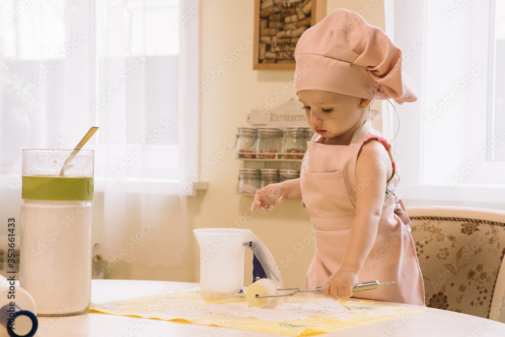 Little girl cooks at home in the kitchen Little girl cooks at home in the kitchen
