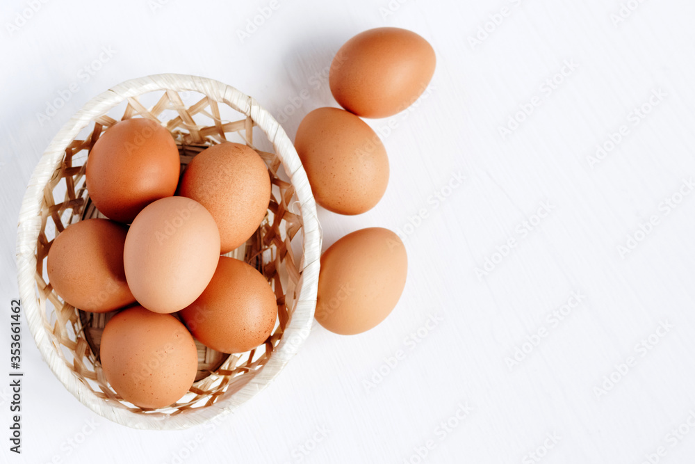 custom made wallpaper toronto digitalBrown chicken eggs in a straw basket on white wooden background. Top view with copy space.