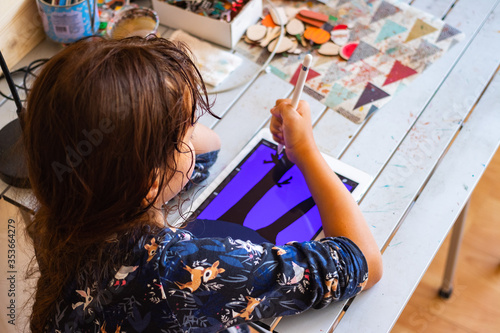 Homeschooling teenager girl study how to draw illustrations and use tablet gadget.