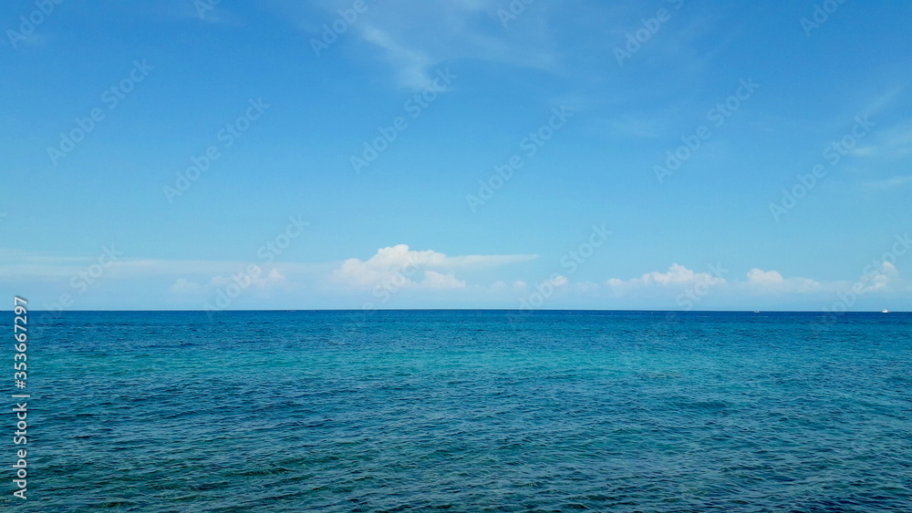 blue ocean calm waves and blue sky on a summer day