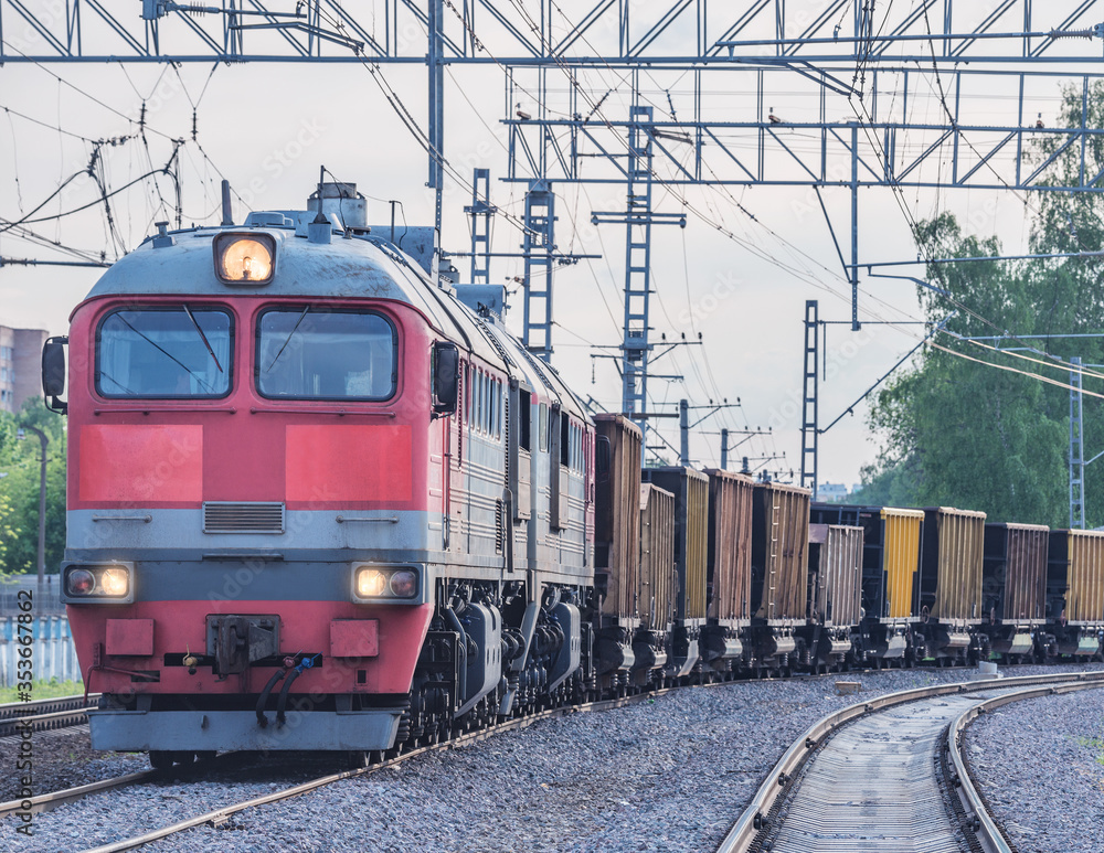 Naklejka premium Freight train departs from the railway station.