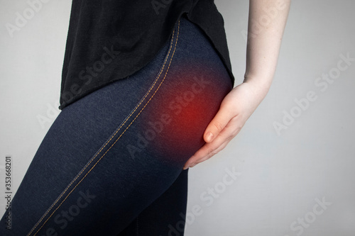 Fotografi A woman suffers from pain in the buttock