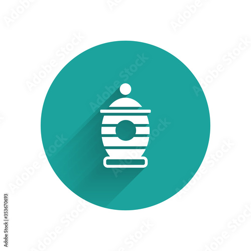 White Funeral urn icon isolated with long shadow. Cremation and burial containers, columbarium vases, jars and pots with ashes. Green circle button. Vector.