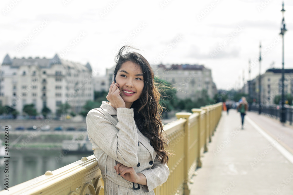 Asian girl with mask is walking on the bridge