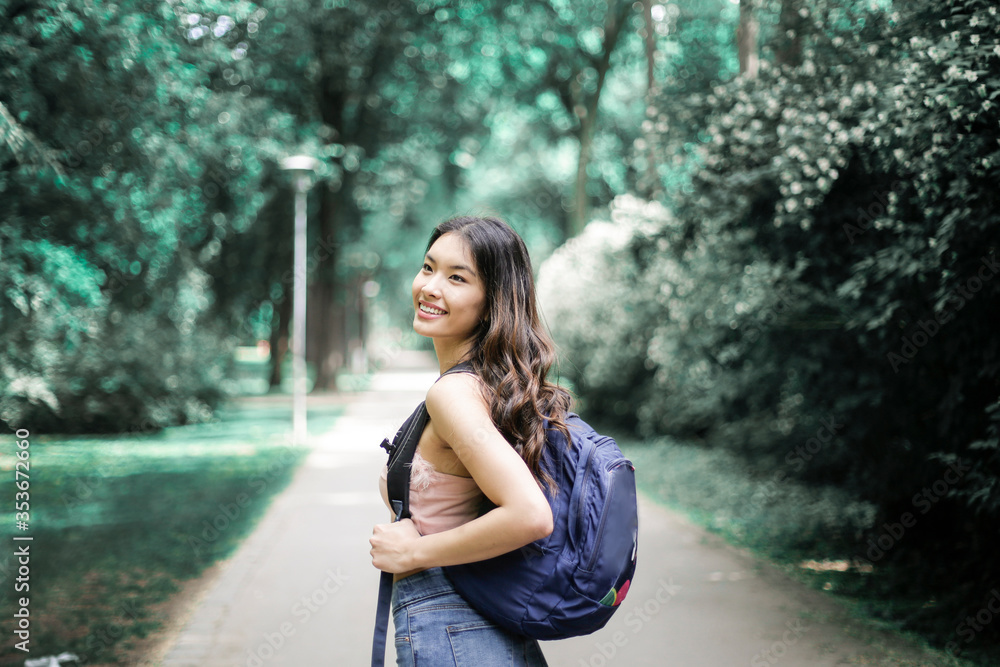 Obraz premium Asian girl is walking in a park