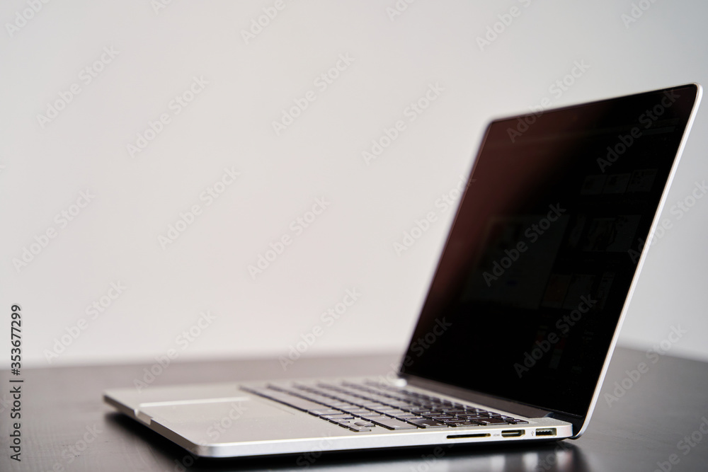 Laptop on a black table close-up, side view