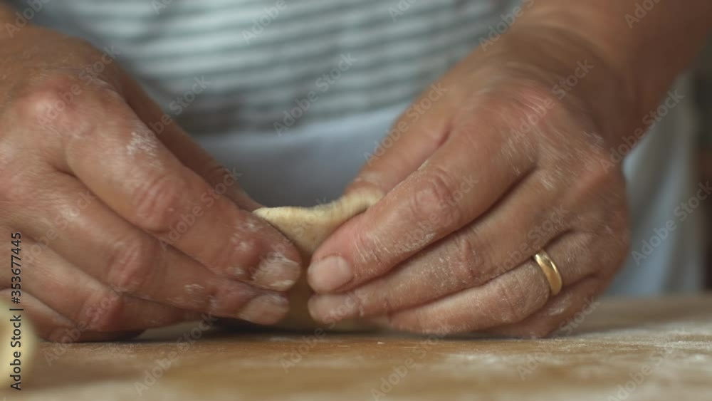 Closeup of woman hands rolling out the organic whole wheat dough at the bakery or in the kitchen. Closeup of woman hands rolling out the organic whole wheat dough at the bakery or in the kitchen.
