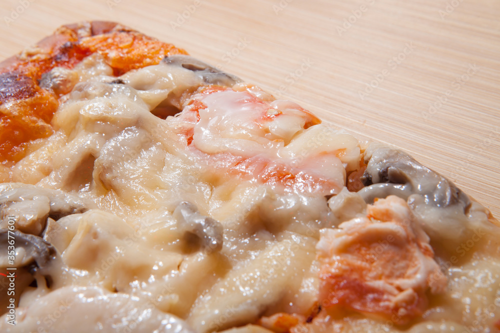 Slice of delicious pizza on the cutting board Slice of delicious pizza on the cutting board