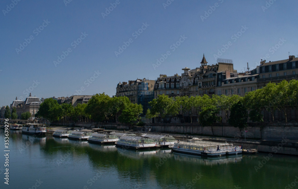 view of the Seine river with boats on it and attractions on the shore in Paris