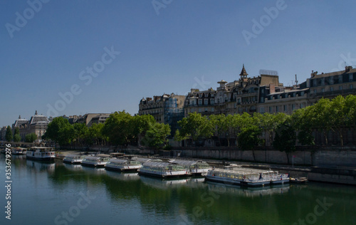 view of the Seine river with boats on it and attractions on the shore in Paris