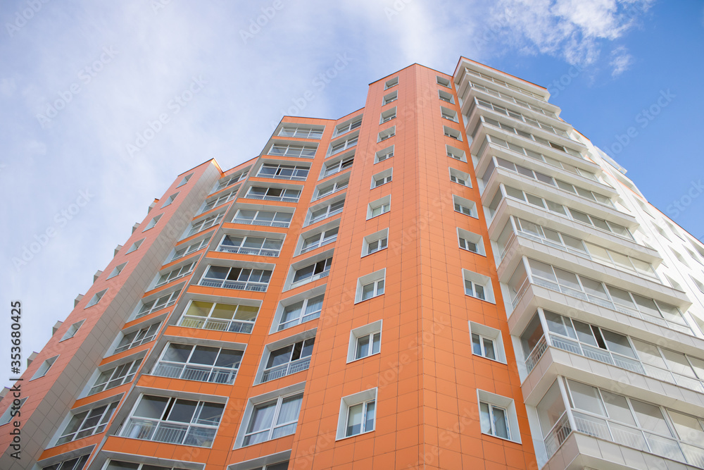 Orange multi-storey building on sky background. Orange multi-storey building on sky background.
