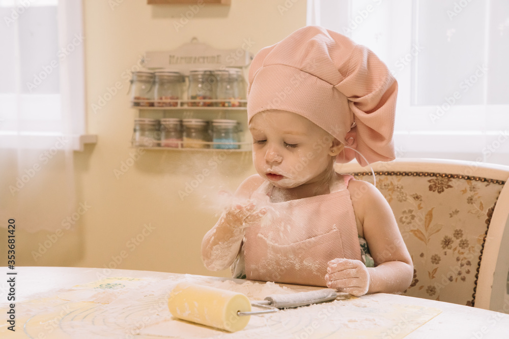 Little girl cooks at home in the kitchen Little girl cooks at home in the kitchen