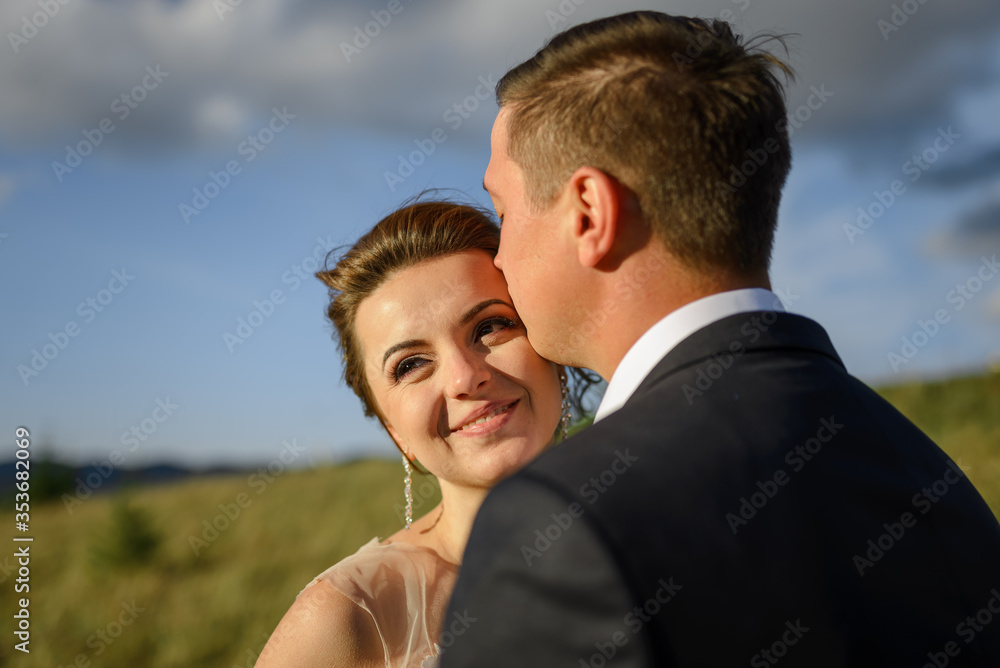 Wedding photography in the mountains. The groom kisses the bride on the forehead. Wedding photography in the mountains. The groom kisses the bride on the forehead.
