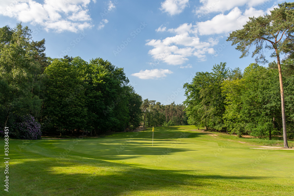 Herkenbosch, The Netherlands - May 27, 2020: The Green and fairway of Hole 6 of Golf & Country Club De Herkenbosche Herkenbosch, The Netherlands - May 27, 2020: The Green and fairway of Hole 6 of Golf & Country Club De Herkenbosche