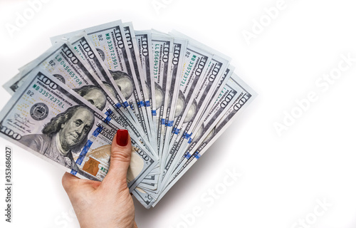 Hundred dollar bills in a woman's hand on a white background. Space for text