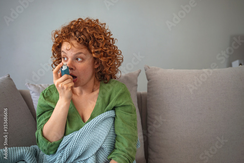 woman using a pressurized cartridge inhaler extended pharynx, Bronchodilator. Daily Life of a Person with Asthma.  