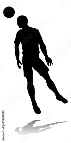 A soccer or football player in silhouette