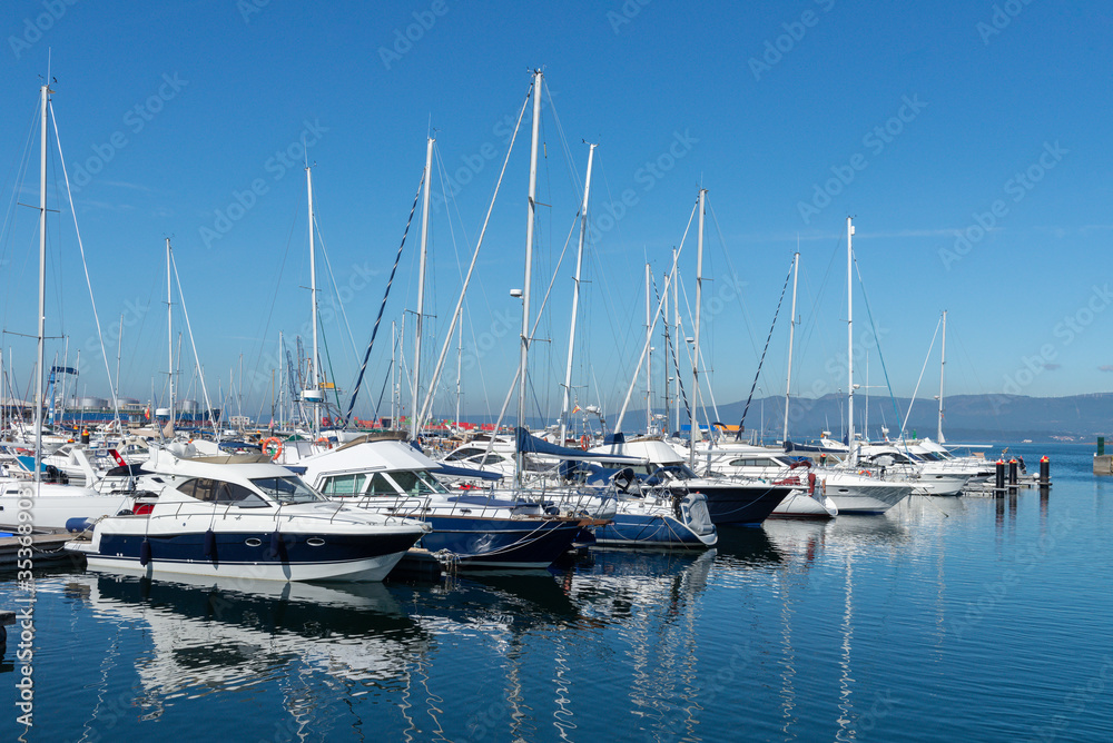 sailing and motor yachts in the seaport in bright sunny weather