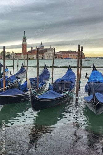 Empty gondolas in the venetian lagoon. Traveling to interesting places in Italy.