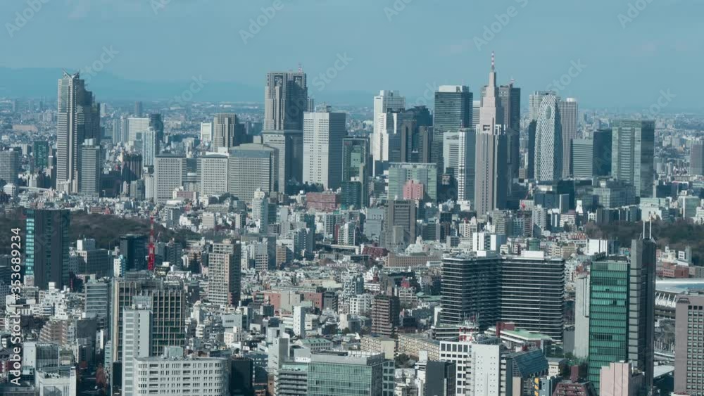 Tokyo cityscape, Japan. Shinjuku district, bird eye view, zoom out camera, 4K time-lapse.