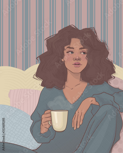 beautiful girl with dark skin and curly hair, drinking a hot drink, sitting on the sofa in her pajamas