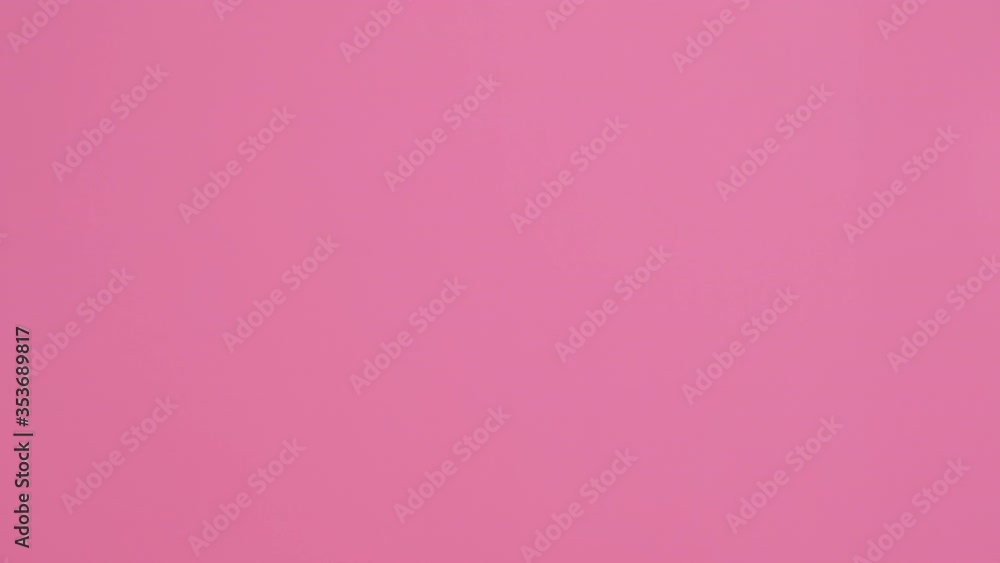 Portrait of happy woman in pink hat welcomes with hand, smiling appears on left side slow motion in pink glasses on pink background. Monotone. Emotions. Positive. Copy space. Advertising Portrait of happy woman in pink hat welcomes with hand, smiling appears on left side slow motion in pink glasses on pink background. Monotone. Emotions. Positive. Copy space. Advertising