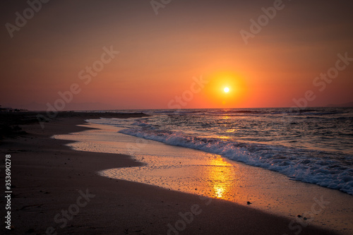 Orange sunset over the city beach