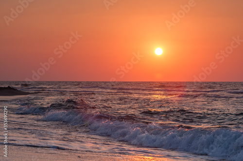 Orange sunset over the city beach