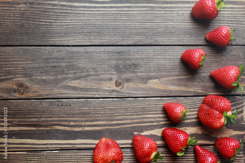 Top view of fresh strawberries on a wooden table