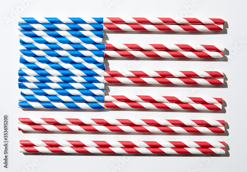 Coloured straws in red and white and blue and white laid out to look like the American flag. photo