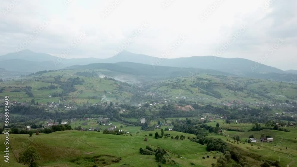 Aerial cinematic view of green forest, mountains and village. drone shot. 4K Aerial cinematic view of green forest, mountains and village. drone shot. 4K