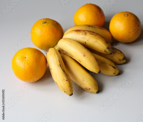 juicy tangerines and ripe bananas on a white background