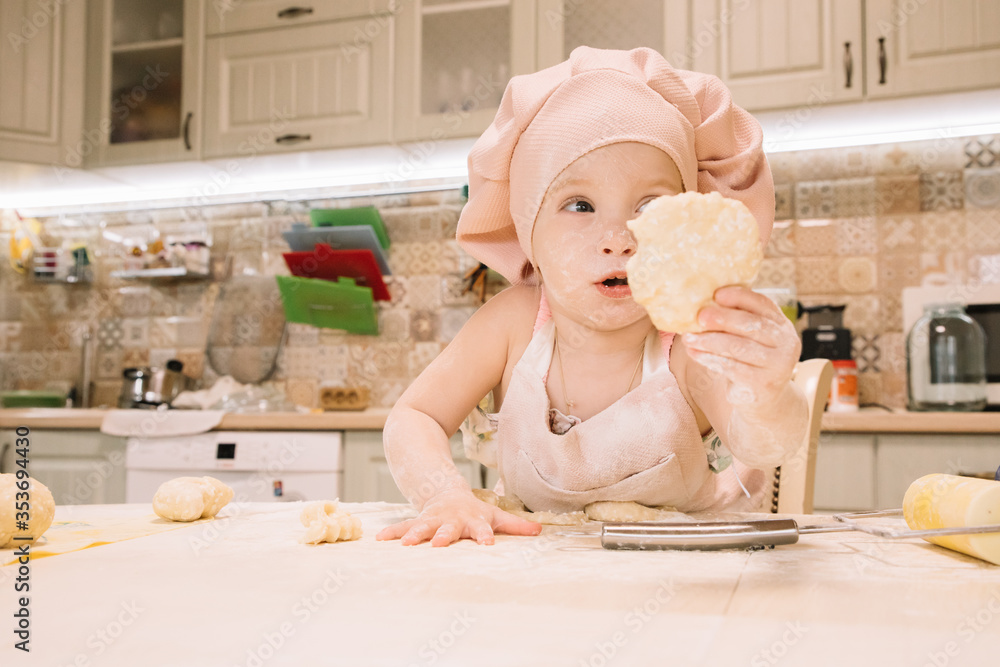 Little girl cooks at home in the kitchen Little girl cooks at home in the kitchen