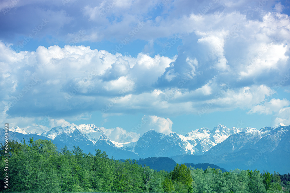 Panoramic view of snow mountain range landscape with blue cloudy sky. Beautiful nature Italy