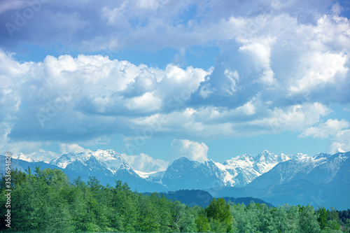 Panoramic view of snow mountain range landscape with blue cloudy sky. Beautiful nature Italy