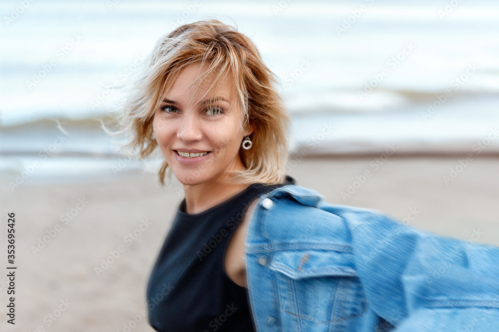 portrait of a girl in the wind near the water portrait of a girl in the wind near the water