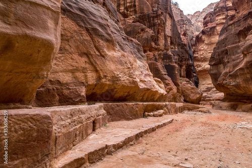  The road to the main facade of Petra among the high red cliffs in Jordan.