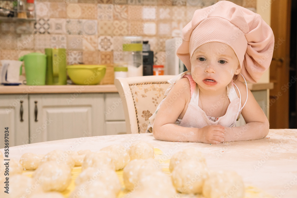 Little girl cooks at home in the kitchen Little girl cooks at home in the kitchen