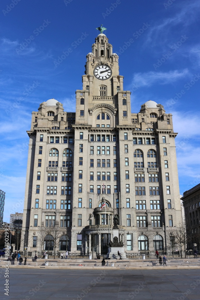 Fototapeta premium Liverpool, Merseyside, England - May 04 2019: Vertical Shot of Royal Liver Building Viewed From River Bank Side