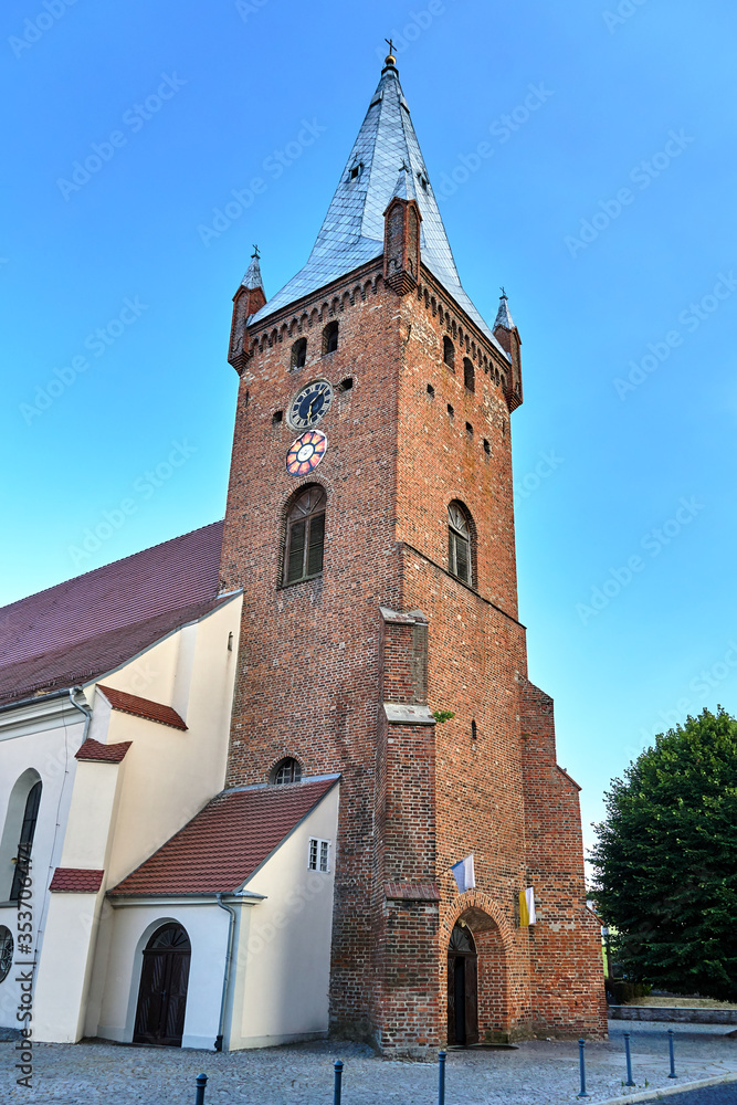 Gothic parish church with a bell tower in the city of Obrzycko in Poland.