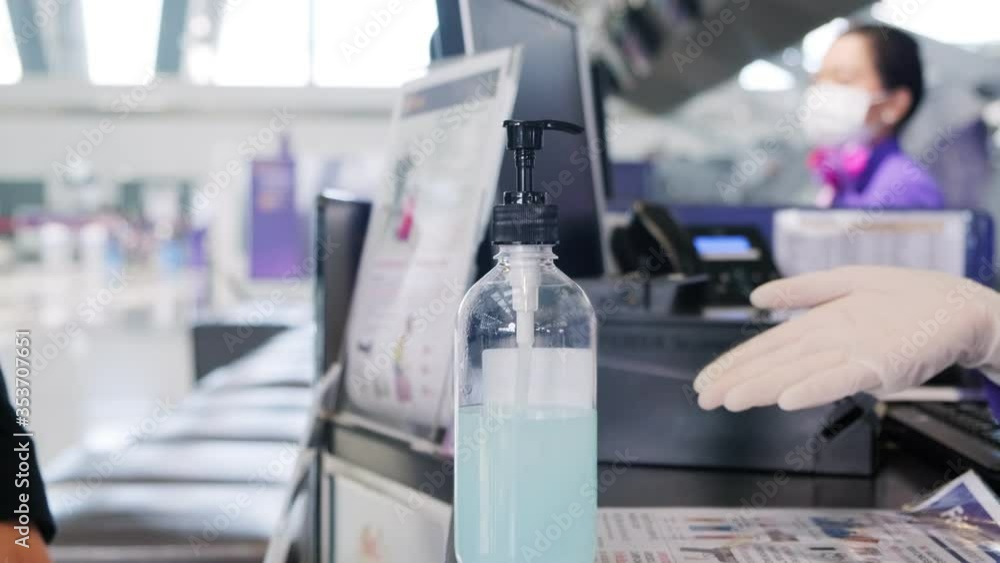 Asian male traveler using hand gel alcohol check in counter. Asian male traveler using hand gel alcohol check in counter.